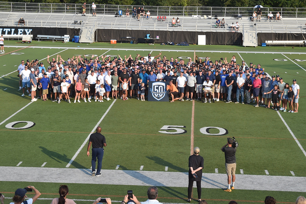 Football alumni gathered on the field