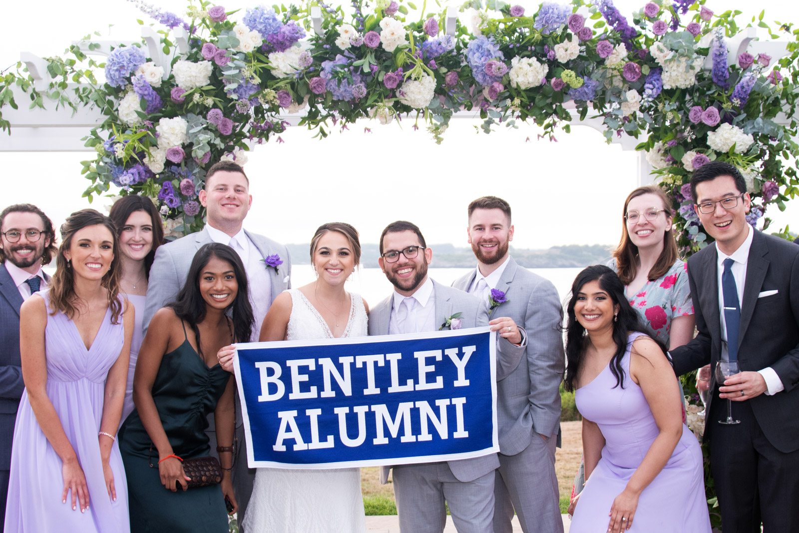 Bentley alumni posing for a wedding photo