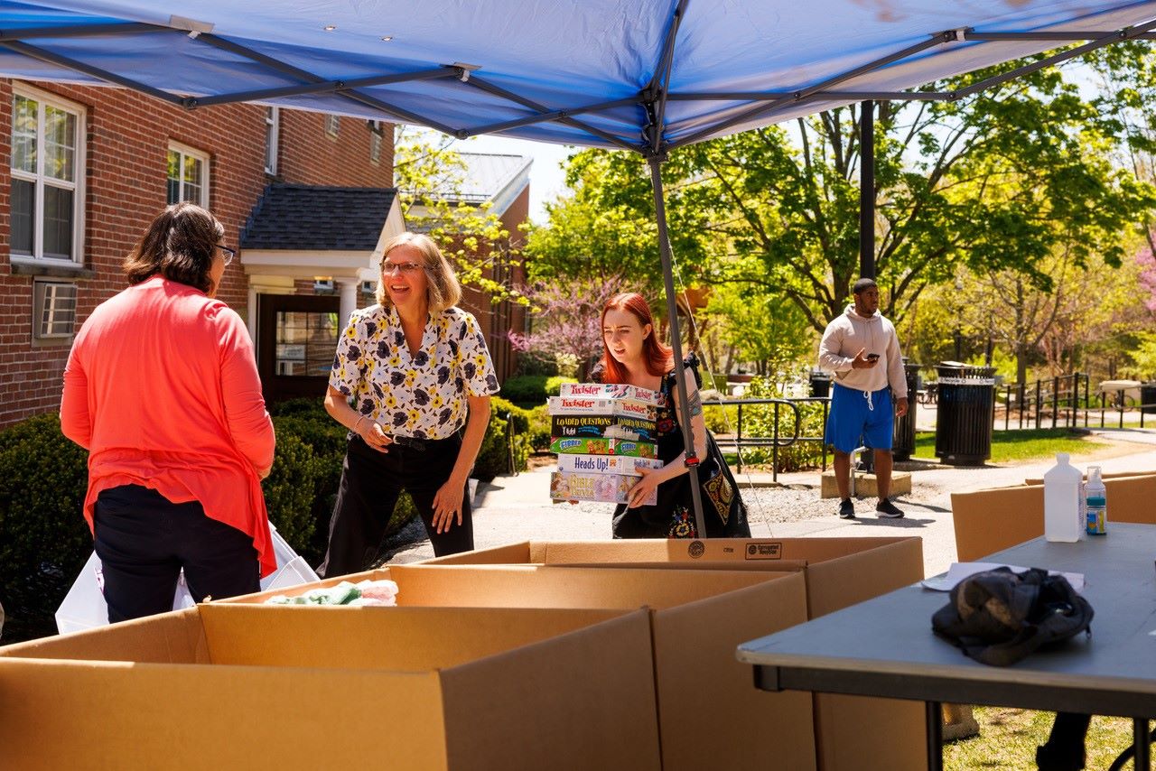 Bentley students donating items at donation tent