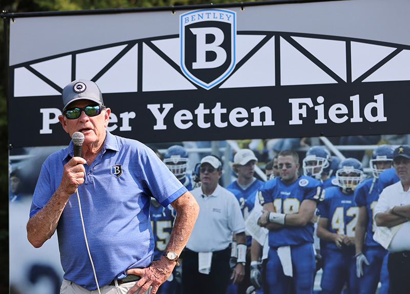 Coach Yetten speaking into a microphone