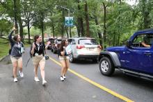3 excited students welcoming cars on move in day 2021