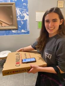 Woman holding pizza box