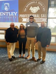 3 Men and one woman in front of a Bentley sign