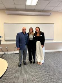 3 people standing in front of a white board