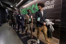 Participants in Celtics Career Day, presented by Bentley University, walk toward the court at TD Garden