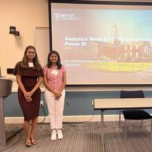 Two people presenting at a business school