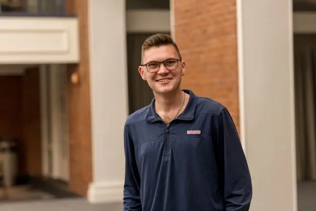Andrew Fox wearing blue shirt and glasses