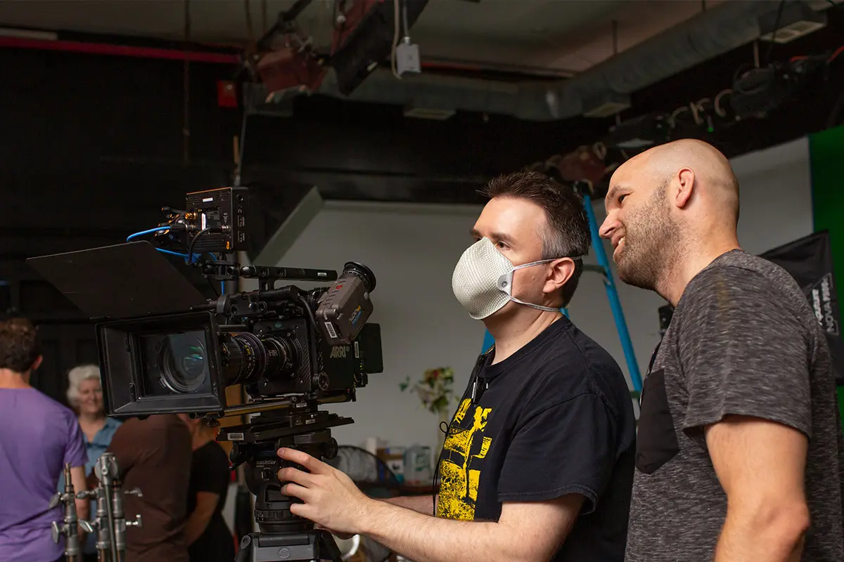 two men setting up a film camera