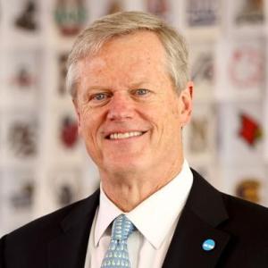 Headshot of NCAA President Charlie Baker, in navy blue suit with baby blue tie