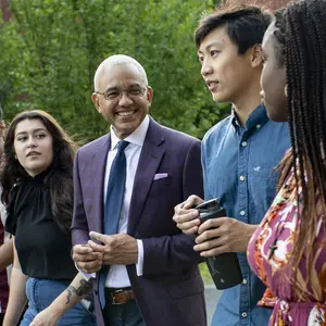 President Chrite walking with students