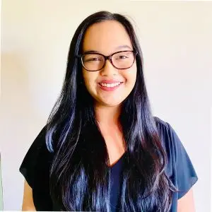 Kerisse Seepersad wearing dark blouse and eye glasses