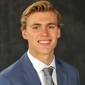 Lucas Vanroboys wearing a suit and tie