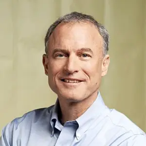 Headshot of Stephen Kaufer, wearing a light grey button-down shirt