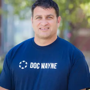 David Cohen, MBA ’01, Bentley alum and CEO at Boston-based nonprofit Doc Wayne, wearing a blue Doc Wayne t-shirt