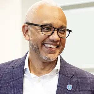 Bentley University President E. LaBrent Chrite smiling and looking off camera