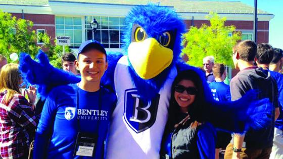 Bentley student Carlos Guttierrez with Flex the Falcon 