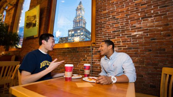 two students talking over coffee in Boston