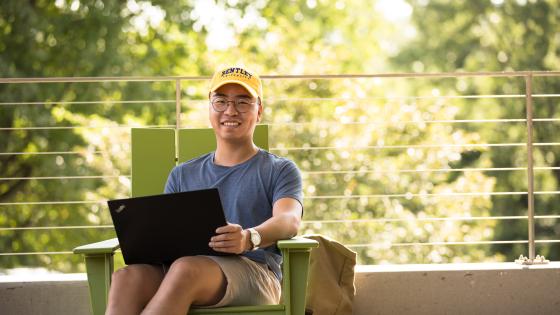 student uses laptop outside of student center