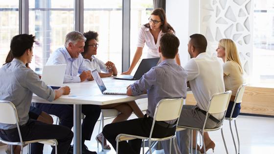 An Employee Resource Group meeting with a group of employees having a discussion at a table