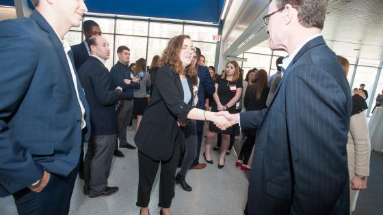 Career mentor shaking hands with student