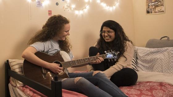 Students at Bentley University play the guitar