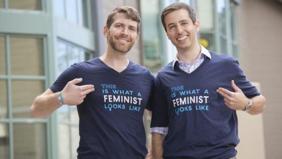 Two men wearing "this is what a feminist looks like" t shirt 