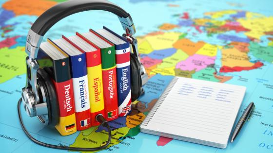 Headphones surround pocket dictionaries in German, French, Spanish, Portuguese and English