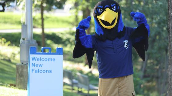 Flex the Falcon mascot with "welcome" sign