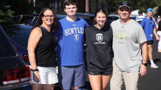 Three family members stand with incoming Bentley student