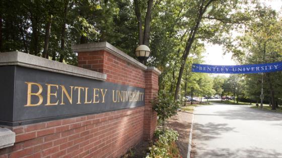 The brick sign that says "Bentley University" at the entrance of the university.