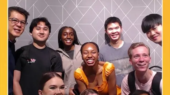 Magazine cover titled "MASGALLERY TIMES" with the subtitle "SINGAPORE." The cover features a group of people standing in front of a geometric patterned background. Prominent text reads "CYBER DEFICIENCY PRODIGIES." The top border includes the words "INTEGRITY," "COMMITMENT," "ENTERPRISE," and "TEAMWORK."