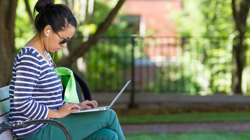 Woman outside on her laptop