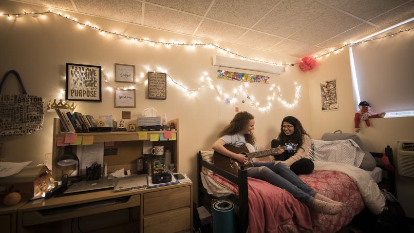 two students hang out in dorm room