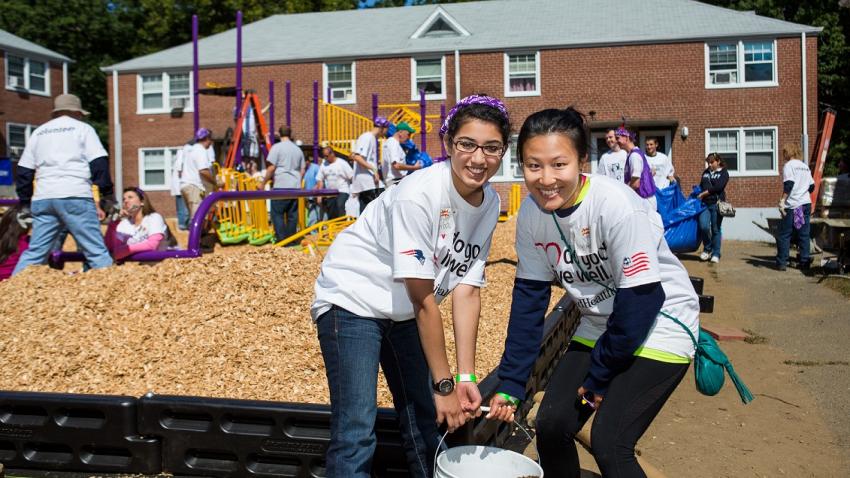Two female students assist with service-learning project.