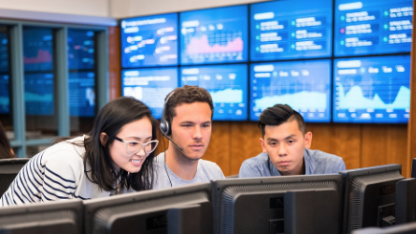 three students in Bentley's trading room
