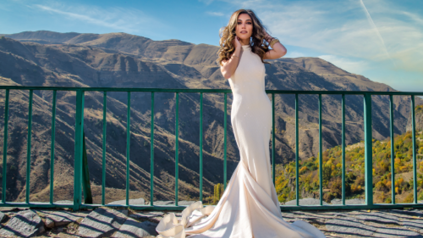 Kristina Ayanian posing in white, long gown