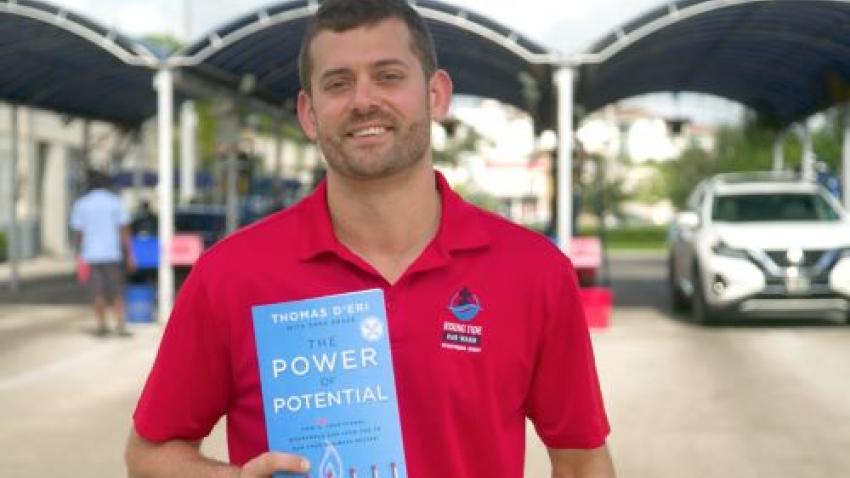 Tom D'Eri holding his book The Power of Potential