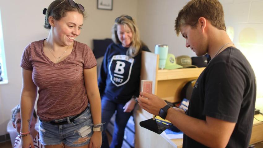Two Bentley students with a mother in dorm
