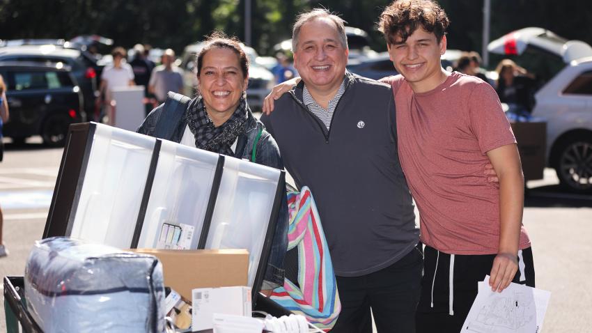 Family members with Bentley student moving items to dorm 