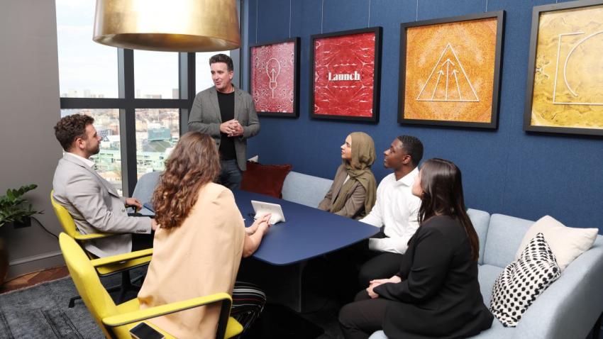Kevin Gillis MBA ’93, partner and COO of Third Rock Ventures, speaks with five Bentley students during their visit to the company's Boston headquarters.