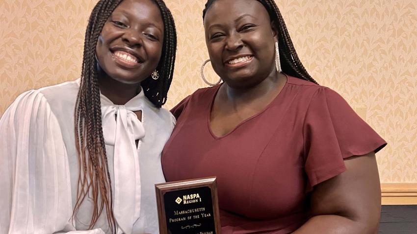 Nana Adu, left, and Dominique Wilburn, right, accept the NASPA Program of the Year Award.