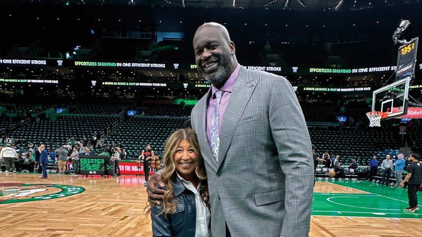 Joanne Borzakian Ouellette ’85, P ’20 ’23 poses with Shaquille O'Neal
