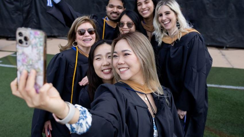 Graduates of the Bentley McCallum Graduate School of Business gather for a selfie during commencement