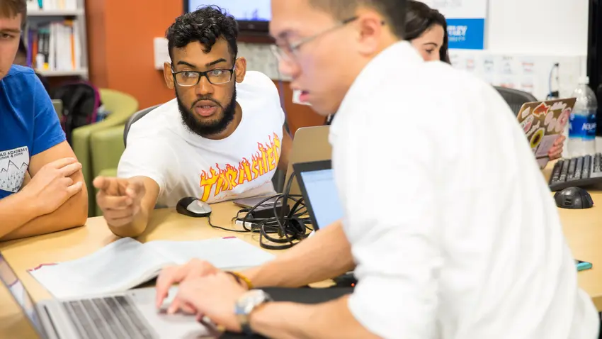 two male students work on a project together in the CIS Sandbox
