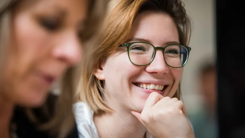 Two female Bentley graduate students in class
