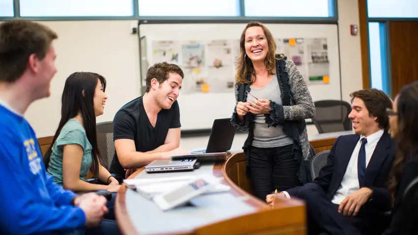 students talk to professor during classs