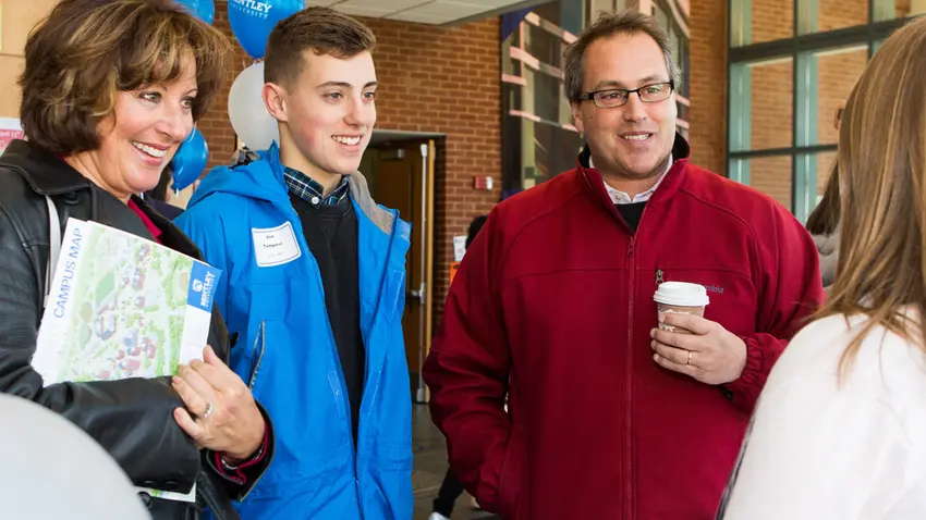 parents talk with staff at event