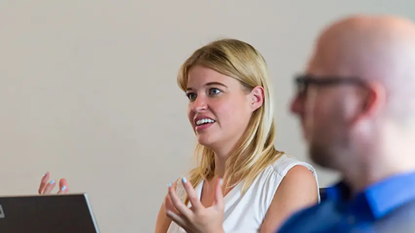 Emerging woman leader asking question in Effective Leadership class