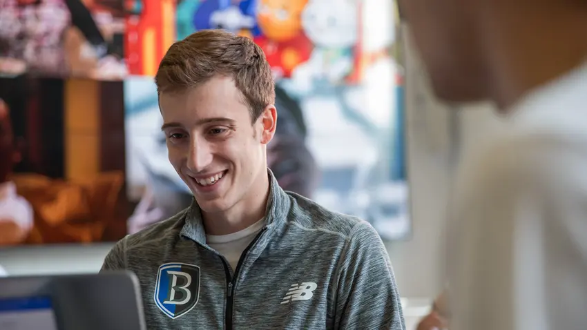 student looks at laptop