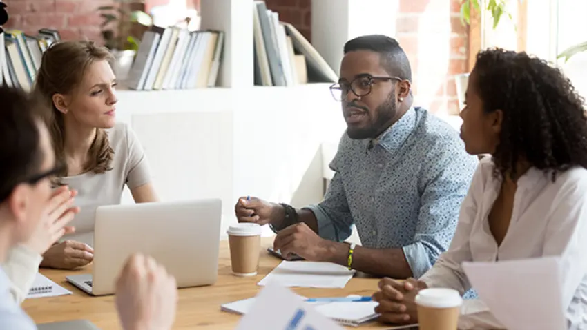 Manager leads team in discussion of new strategic plan